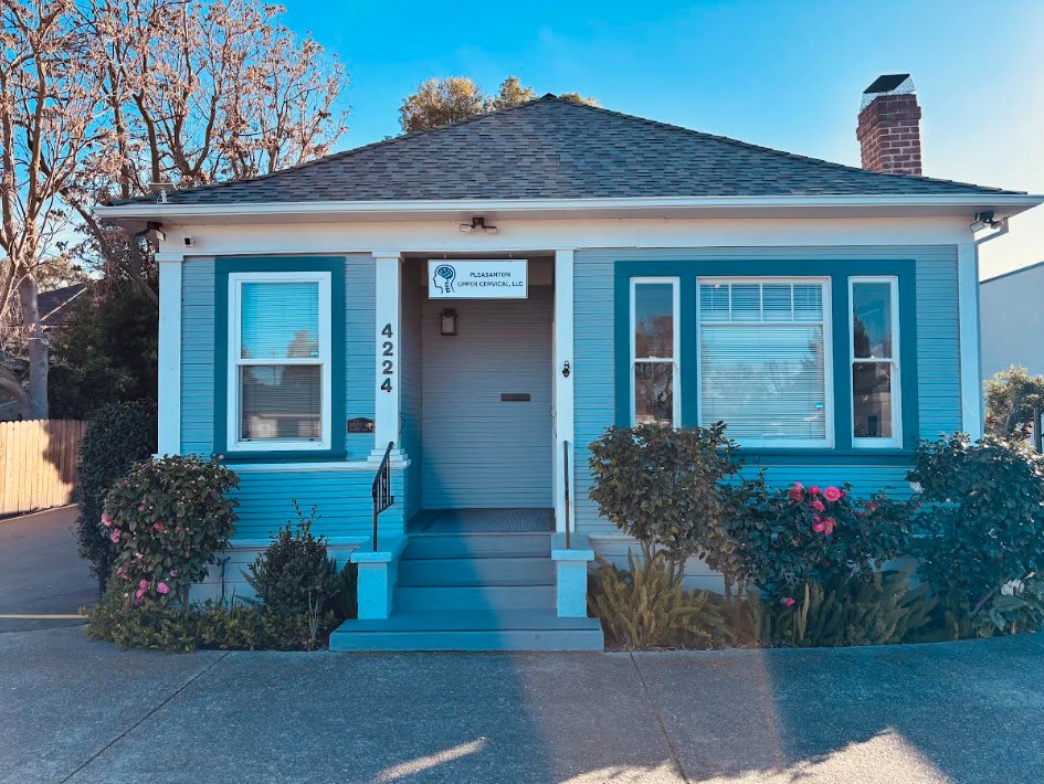 The Pleasanton Upper Cervical office, a light blue house at 4224 Stanley Blvd
